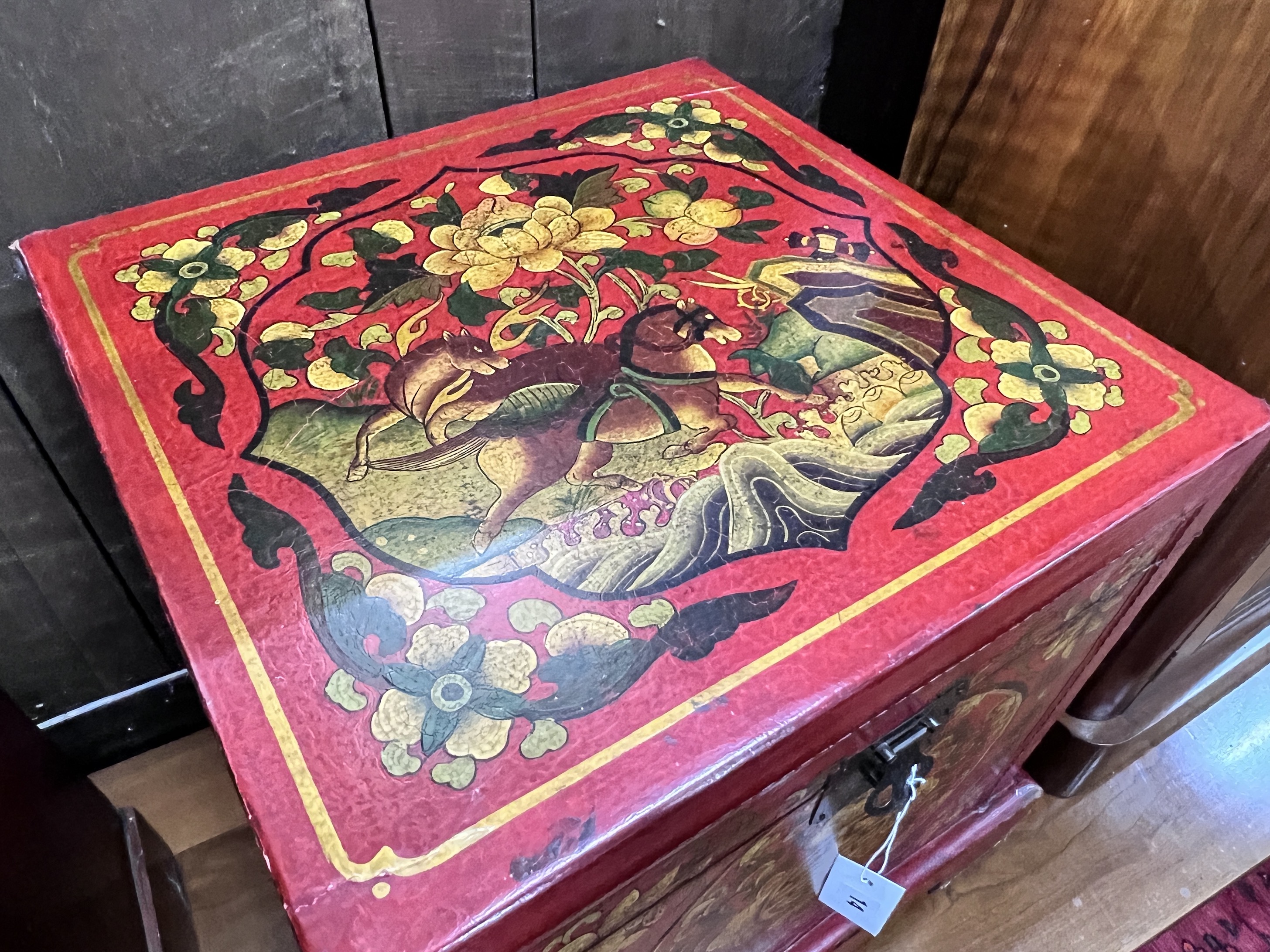 A modern Chinese red lacquer square painted trunk, 47cm, height 44cm